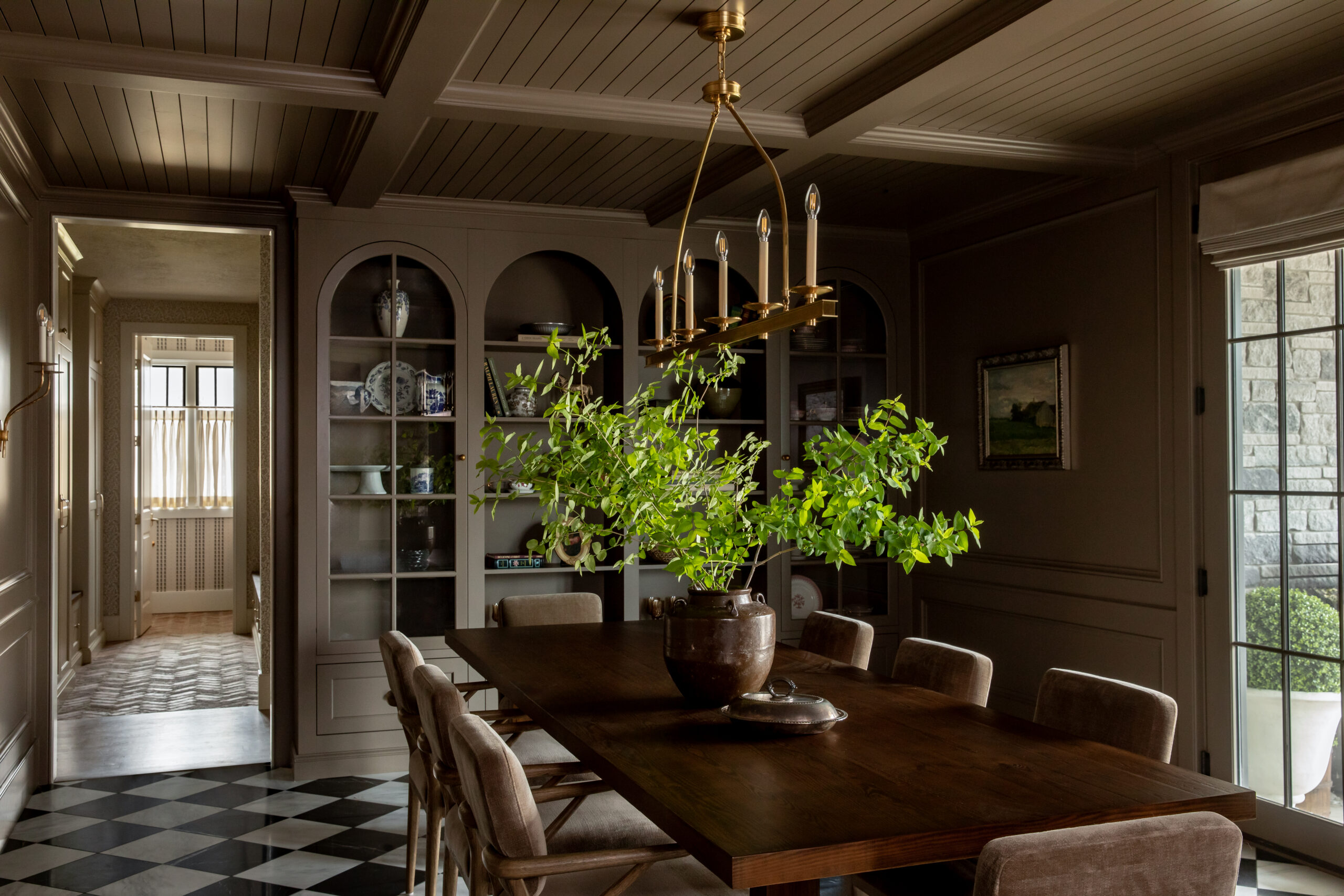 Luxury dining room with coffered wood ceiling, custom built-ins, and moody architectural detailing in a Utah custom home