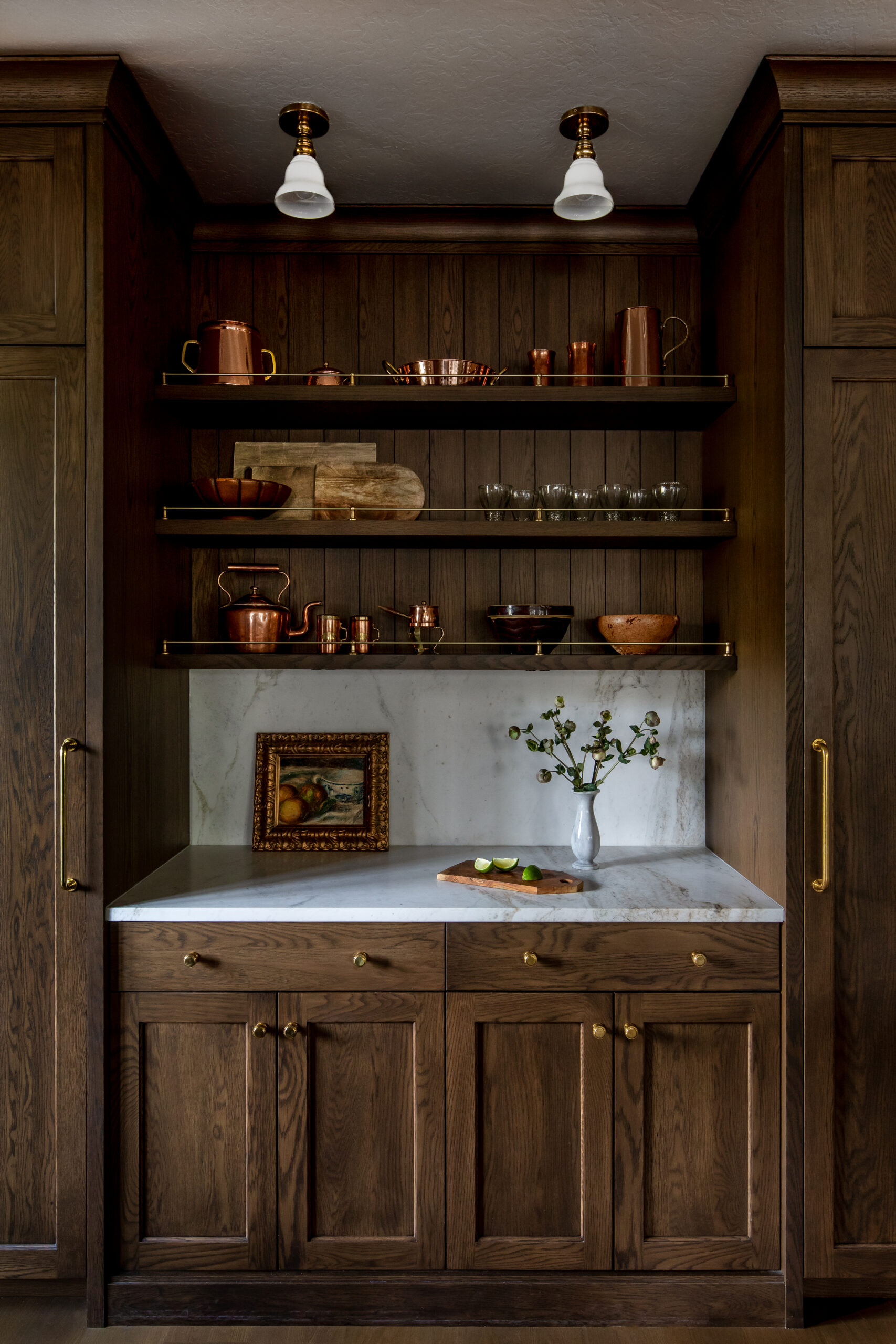 Custom kitchen coffee bar with open wood shelving, marble backsplash, and rich walnut cabinetry in a luxury Utah home